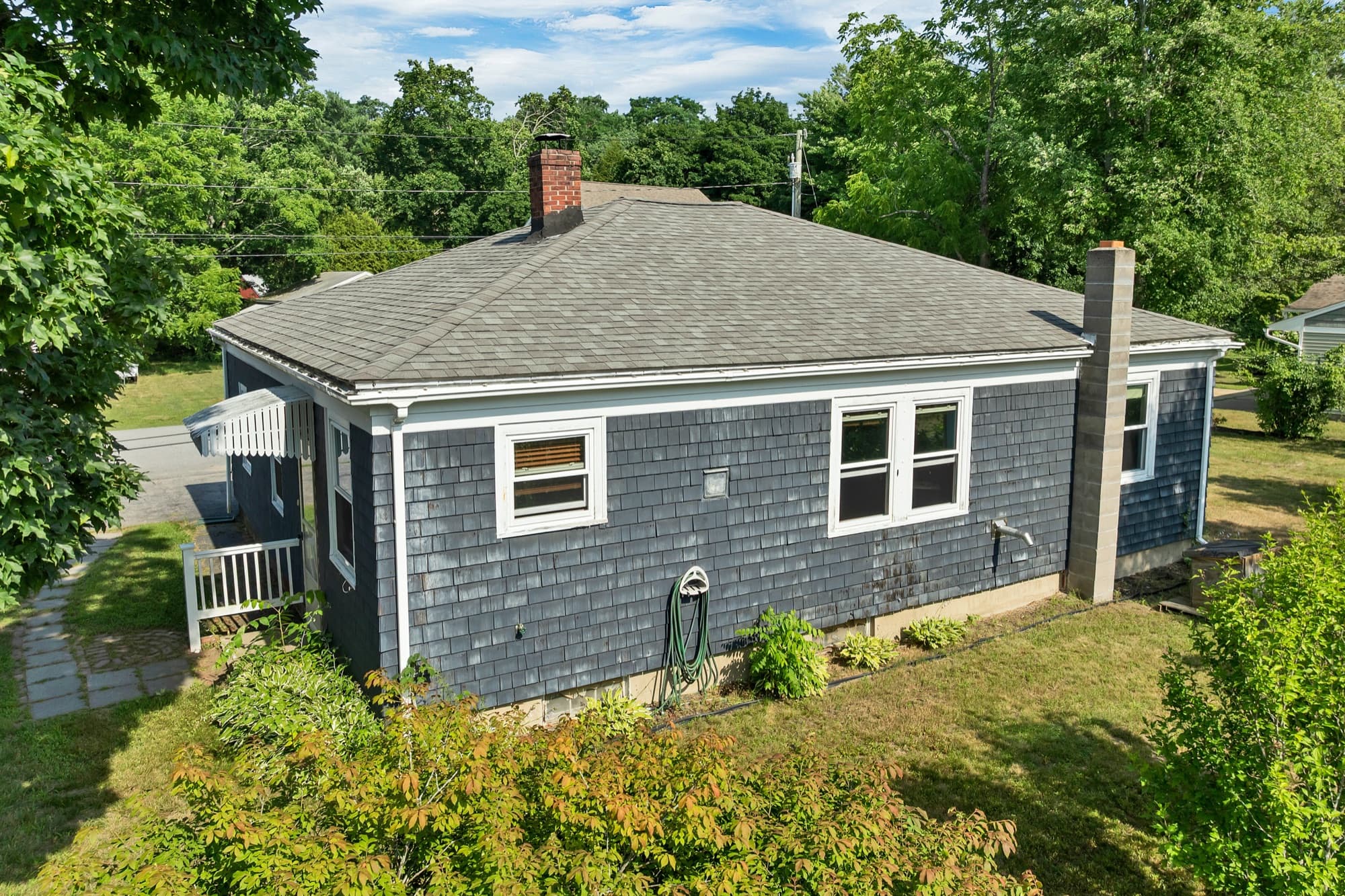 Side elevation with the brick chimney and a side entry deck