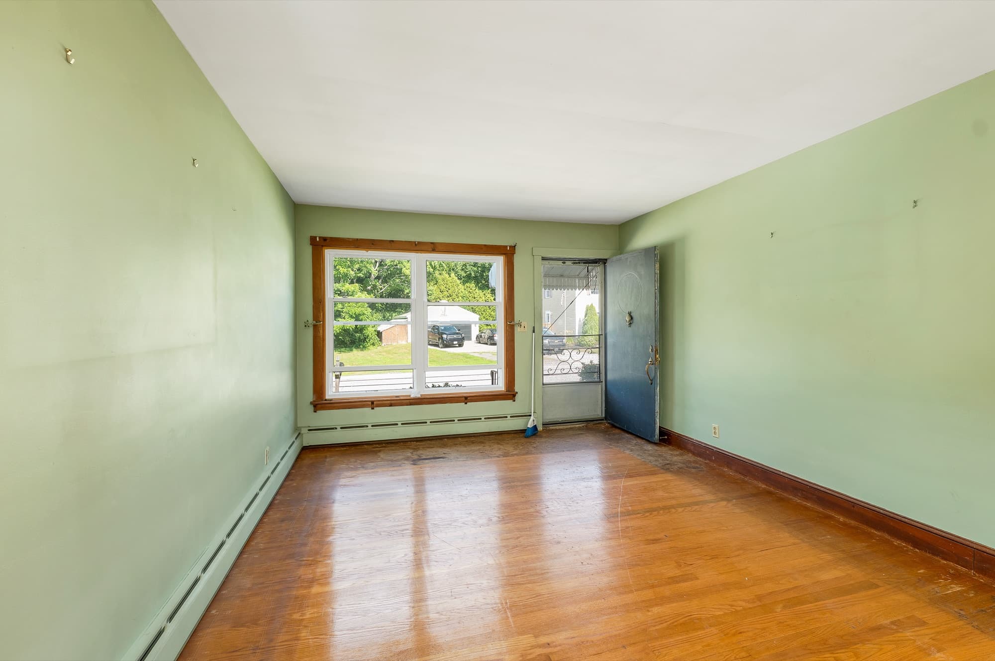 Dining area with hardwood floors and a large window